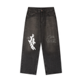 Men's loose vintage wash heavyweight denim jeans in charcoal black with white graffiti graphics on the legs.