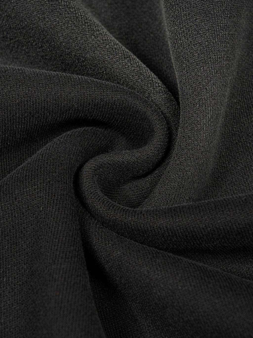 Close-up of the heavyweight sun-fade black cotton blend fabric on an oversized boxy hoodie for a vintage wash look.