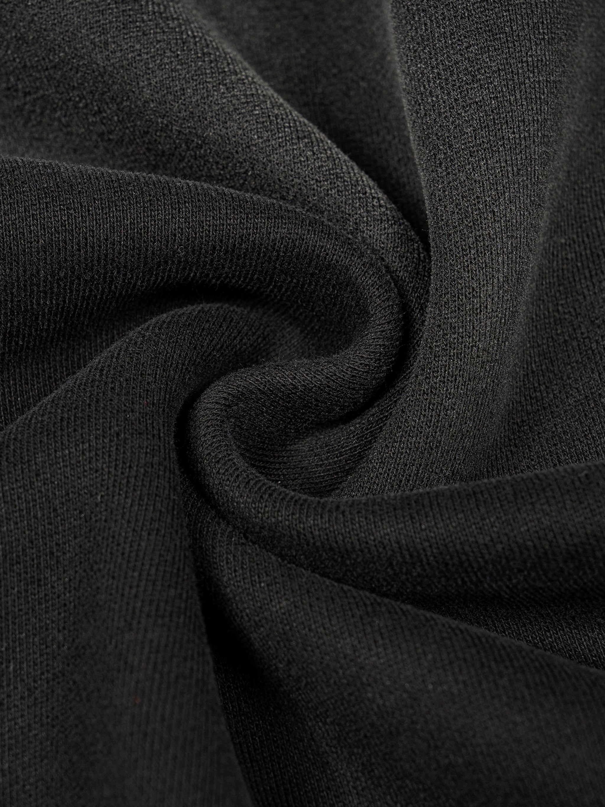 Close-up of the heavyweight sun-fade black cotton blend fabric on an oversized boxy hoodie for a vintage wash look.