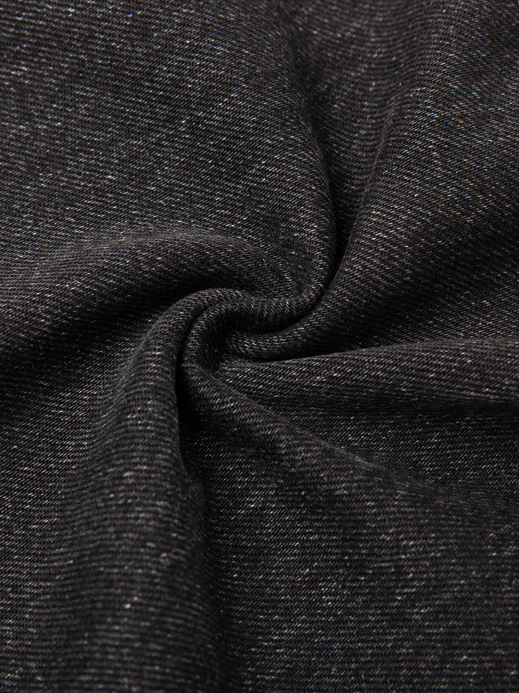 Close-up of vintage wash heavyweight denim fabric in black, showcasing the 12.4 oz cotton blend weave and texture.