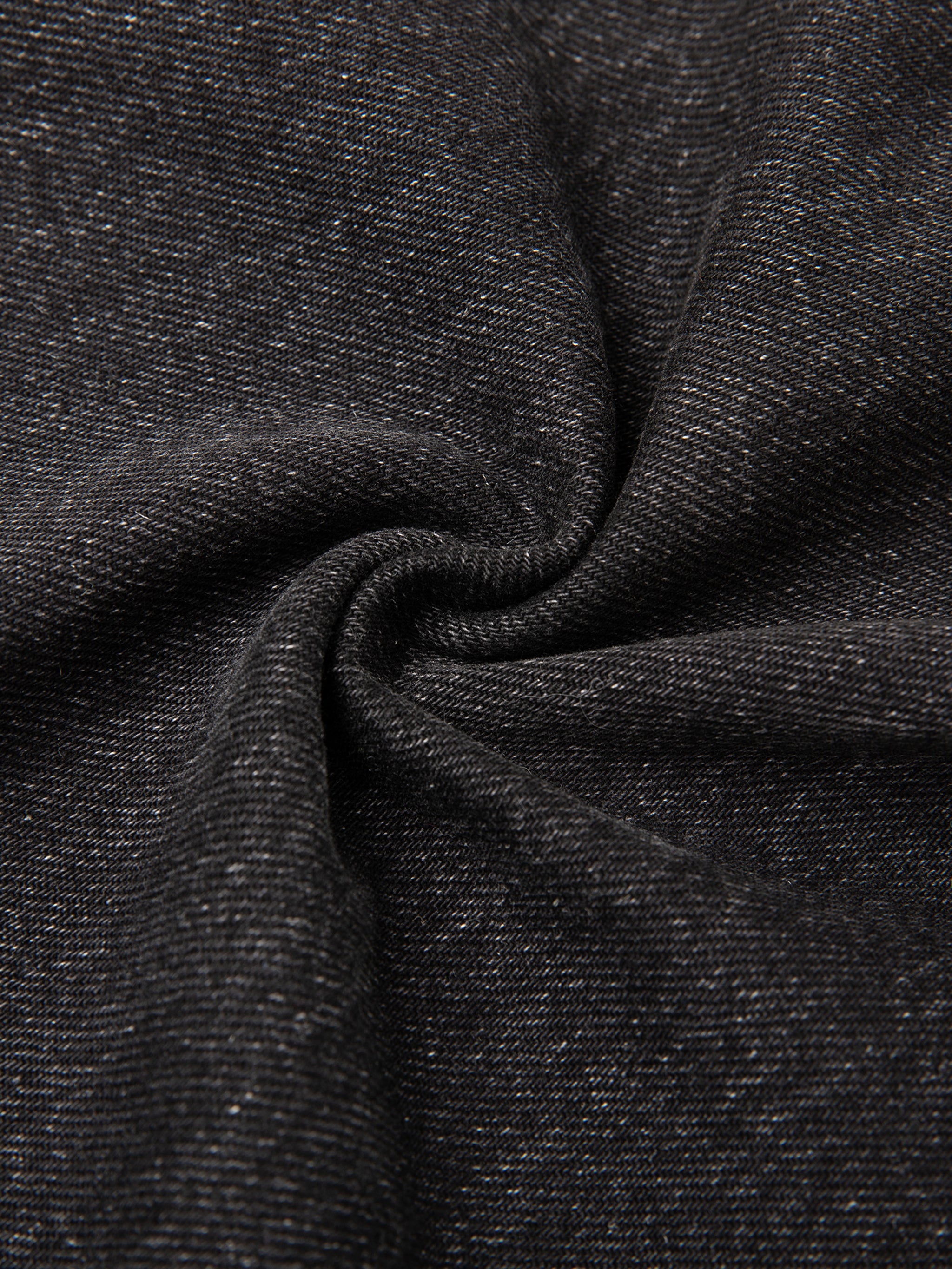 Close-up of vintage wash heavyweight denim fabric in black, showcasing the 12.4 oz cotton blend weave and texture.
