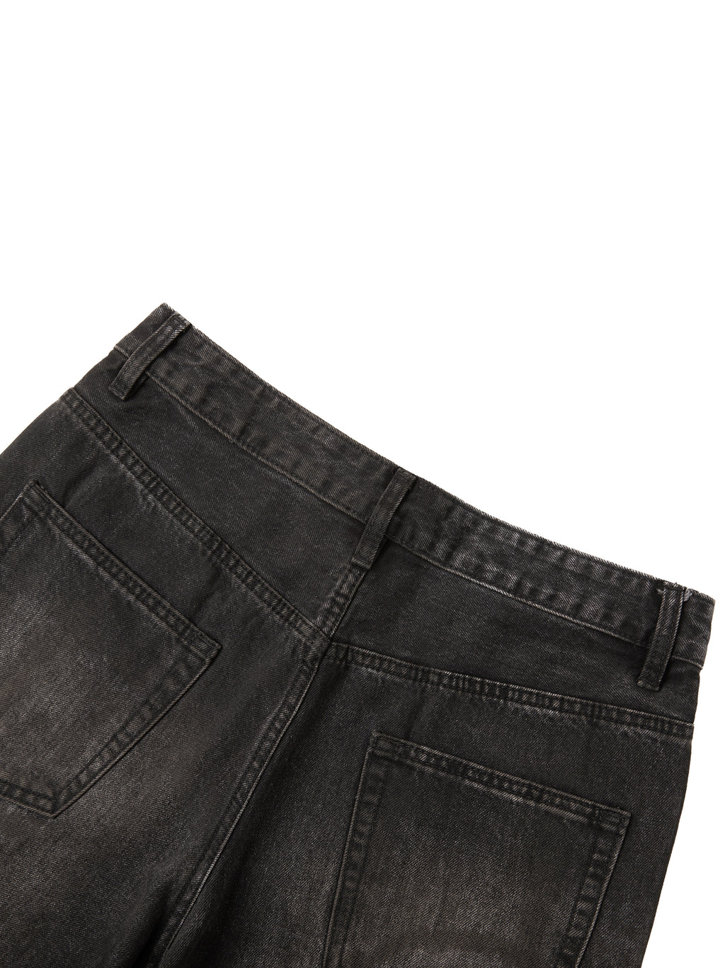 Close-up of back waistband and pockets on men's vintage wash black heavyweight denim jeans.