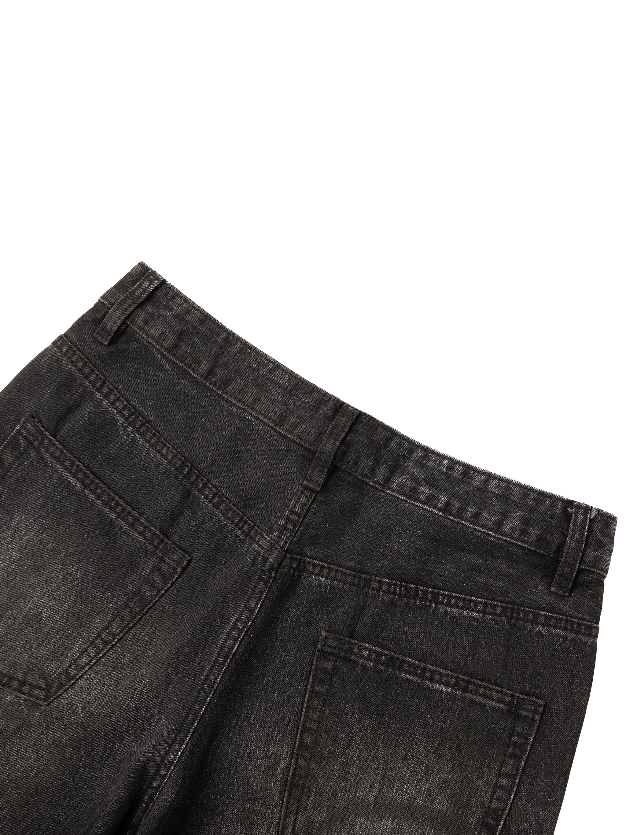 Close-up of back waistband and pockets on men's vintage wash black heavyweight denim jeans.